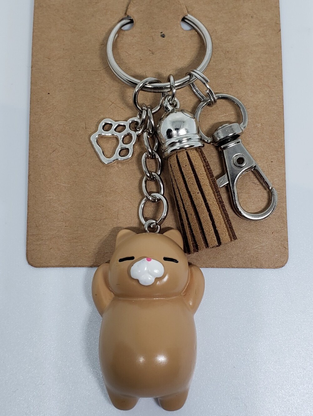 Handmade painted resin light brown tan cat paw keychain